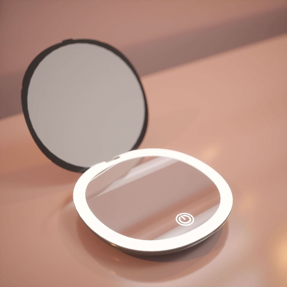 The Black Compact Mirror with Light is a round, open LED-lighted makeup mirror with a touch-sensitive power button, perfect for easy use anywhere. It sits on a glossy pink surface and is portable for your convenience.